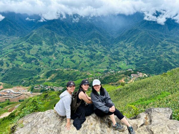 two girls stop on the mountain during the trek