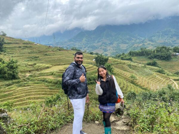 hmong guide and tourist doing trekking in sapa