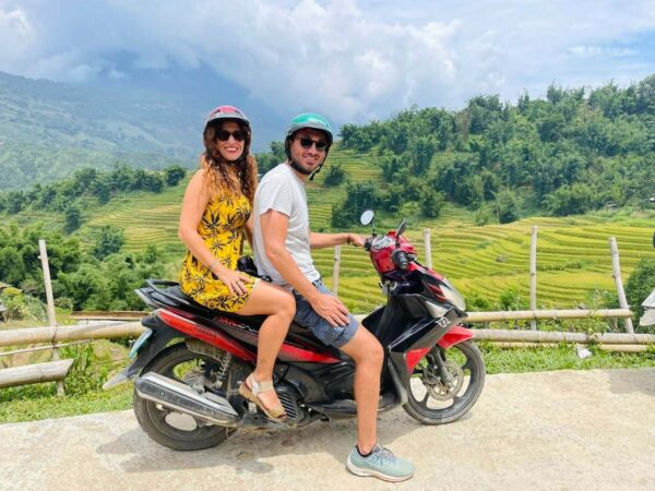 two people riding motorbike during gorden rice fields