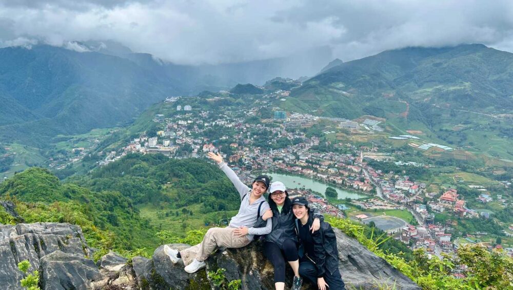 three travelers on a Sapa 2-day 1-night adventure trekking tour through mountain
