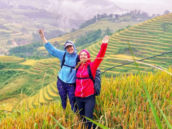 two guests trekking through terraces rice